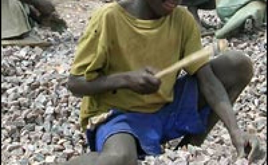 A young boy crushes rocks into gravel at a quarry in the Acholi Quarter, a slum in Kampala, Uganda. Hundreds of thousands of people have lost their homes amid the conflict between the Ugandan government and the rebels of the Lord's Resistance Army.