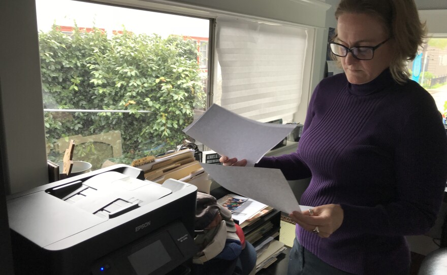 Heather Altman looks through old health insurance bills in her Long Beach home office, Jan. 16, 2019