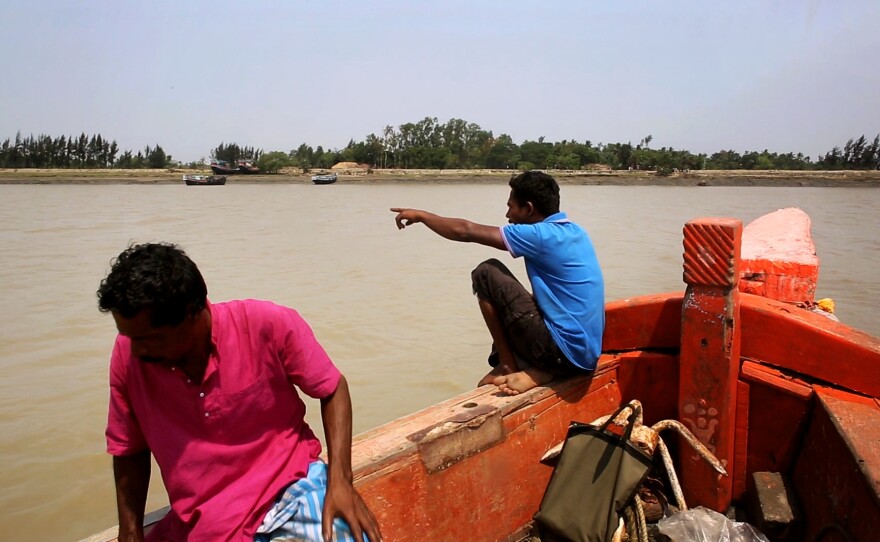 A boat approaches Ghoramara island in India's Sundarbans. Most traffic goes the other way, as thousands of Ghoramara residents have left the flood-prone island in recent years.