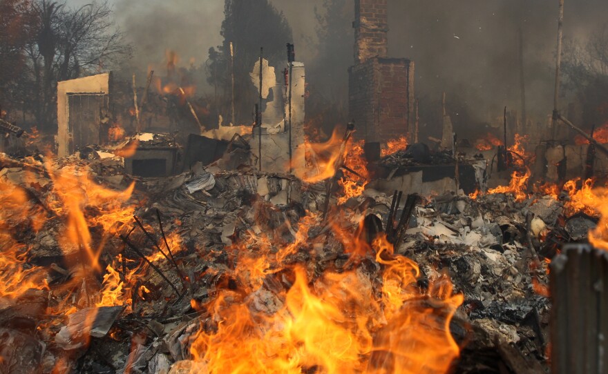 A house burns at the Cocos fire in San Marcos, Calif., Thursday. Fire agencies are girding for what is already proving to be a dangerous year of wildfires, as California suffers an extreme drought.