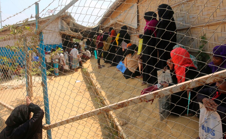 Rohingya refugees wait at a relief distribution point in the Kutupalong refugee camp in Bangladesh on March 24.
