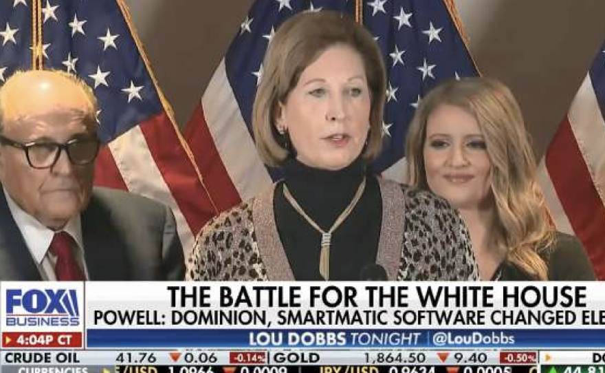 Sidney Powell, center, and Rudy Giuliani, left, are defendants in a new lawsuit filed by the electronic voting systems maker Smartmatic. The company is seeking more than $2.7 billion over what it says was a "disinformation" campaign about its role in the 2020 election.