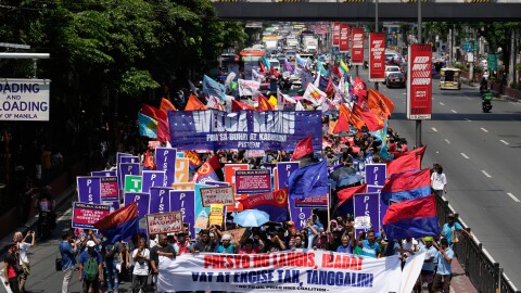 Protesters march during a rally by transport workers and activists protesting the rise in oil prices on Friday, March 27, 2026, near the Malacanang presidential palace in Manila, Philippines.