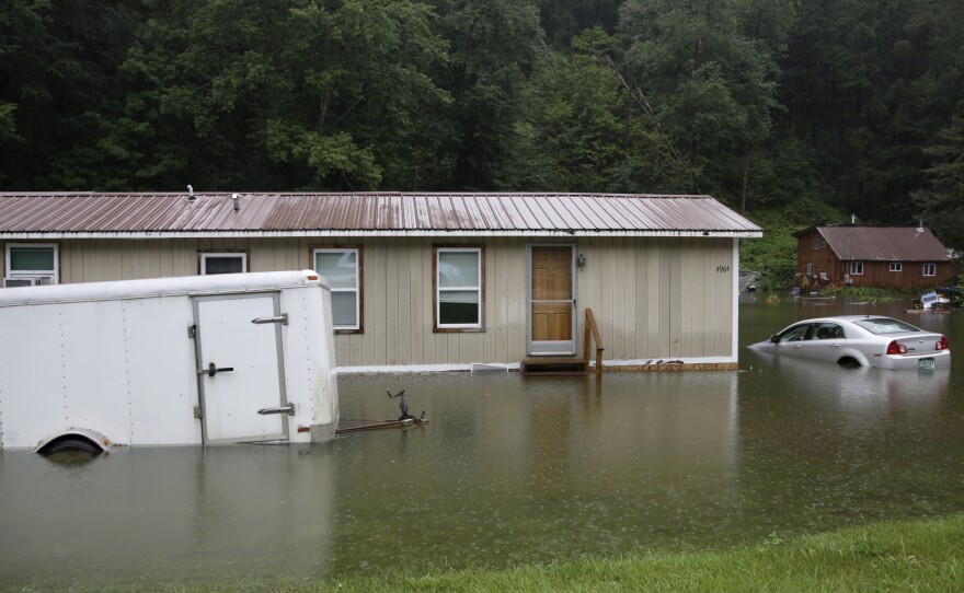Flooding in Bridgewater, Vt., in July 2023 submerged vehicles and flooded buildings. Americans are sad, anxious and often motivated to act about climate change according to a new survey.