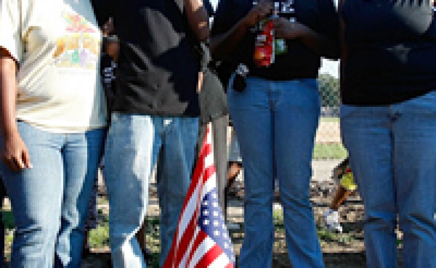 Protesters gather on the spot where a tree once stood on the Jena High School campus. Several nooses were hung from the tree, once a hangout for white students, after a black student sought to sit under it.