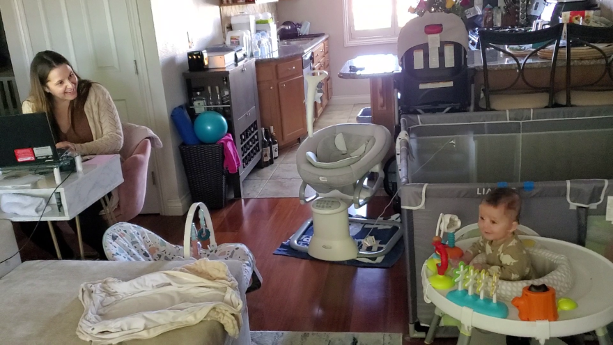 Ariana Steck works in her North Park apartment while her six-month-old son Griffin plays nearby, May 11, 2022.