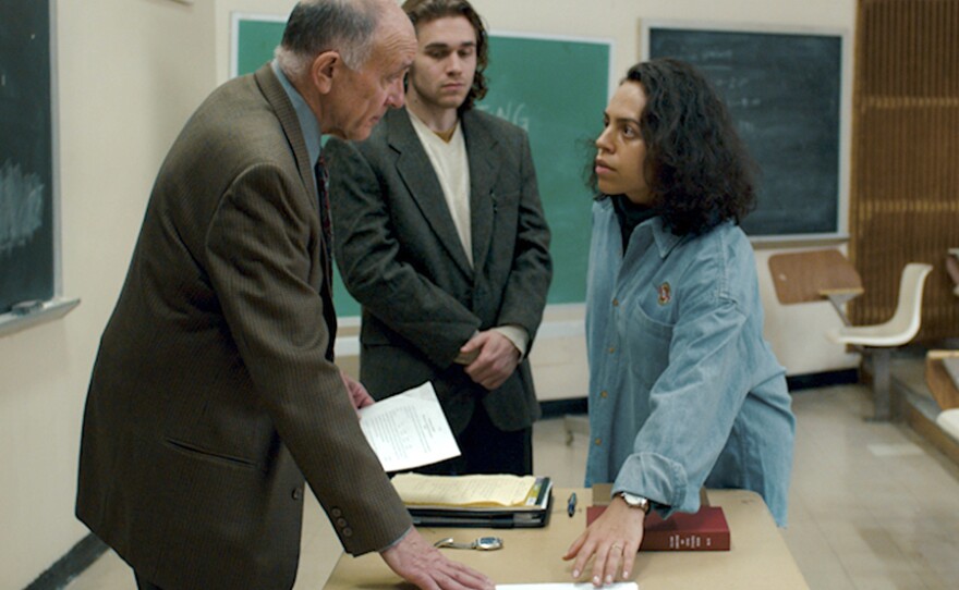 Film still from "“Pasos de Valor." Professor Holtz (Dean Kyburz) tells Valentina (Nathalie Carvalho) she’s not able to get the next section of the exam until she returns from breastfeeding. He fears she might use the break somehow for cheating.
