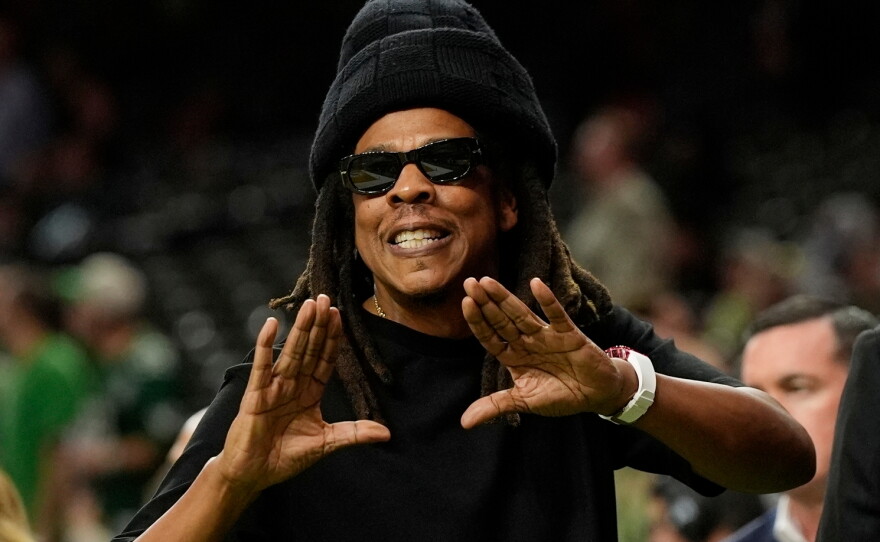 FILE - Jay-Z gestures from the sidelines prior to the NFL Super Bowl 59 football game, Feb. 9, 2025, in New Orleans.