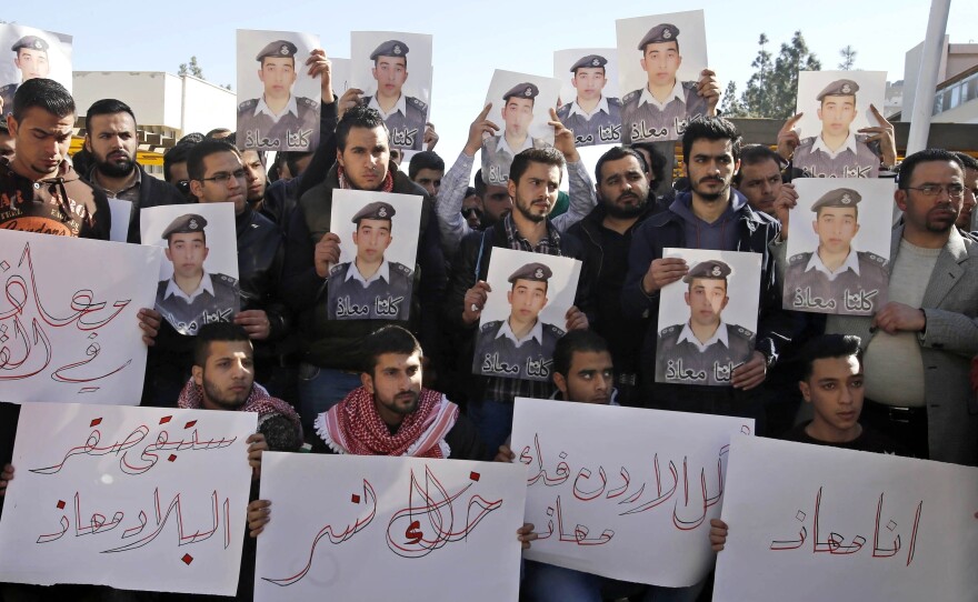 Supporters of Jordanian pilot Lt. Muath al-Kaseasbeh hold posters of him that read, "We are all Muath," during a protest in Amman, Jordan, on Tuesday.