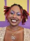Woman smiling at camera with vibrant background