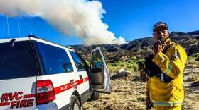 A Cal Fire firefighter from Riverside helps fight the Cutca fire near Palomar Mountain in the Cleveland National Forest, July 24, 2015.