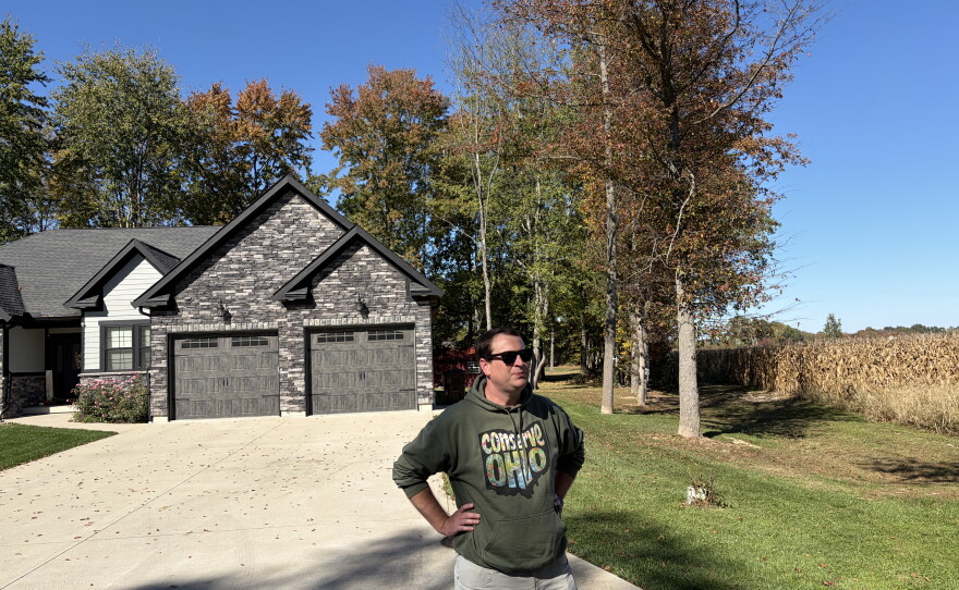 Nick Owens, an attorney in Brown County, Ohio, stands at the edge of a Mt. Orab neighborhood next to farmland that has been sold to a data center developer. Owens is leading an effort to halt the buildout of hyperscale data centers in communities like this one.