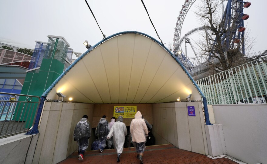 Participants take refuge underground during an evacuation drill simulating a North Korea ballistic missile attack Monday in Tokyo.