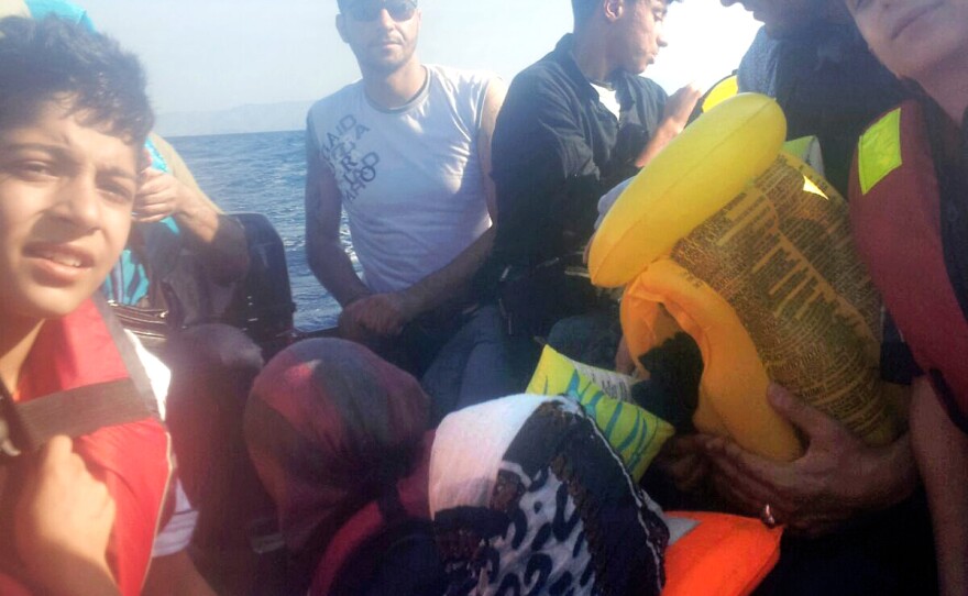 Refugees are crammed together on a raft during the journey from Izmir, Turkey, to Lesbos, Greece.