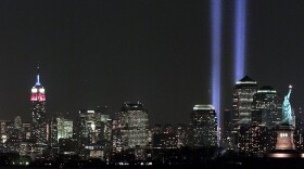The 'Tribute in Light' memorial shines behind the Statue of Liberty on the anniversary of the World Trade Center terrorist attacks in New York City.