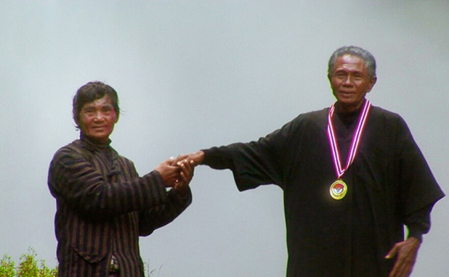 Anwar Congo receiving a medal.