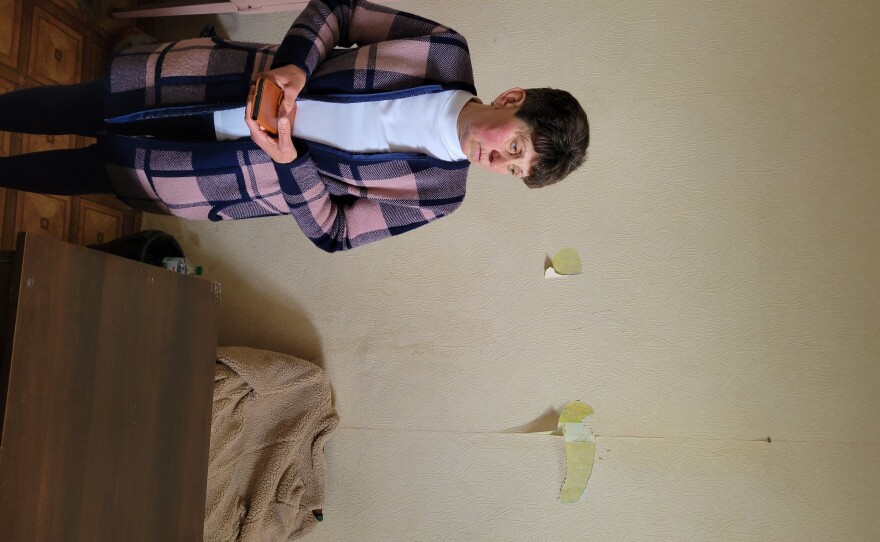 Viktoria Andrusha's mother, Kateryna Andrusha, in her office, damaged by Russian soldiers.