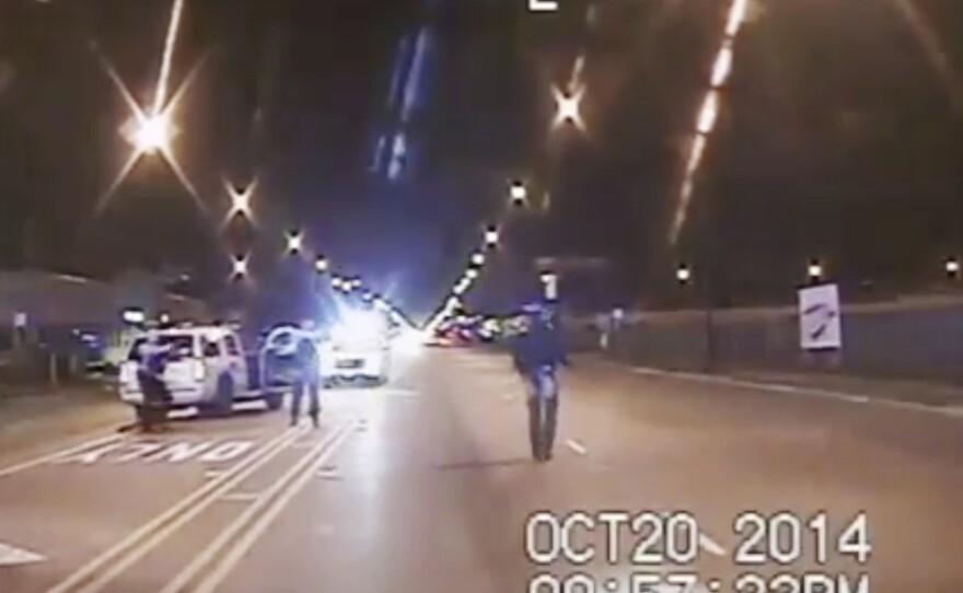 In this Oct. 20, 2014, image made from police dashcam video, Laquan McDonald, 17, right, walks down the street moments before being fatally shot. The images contradicted initial police accounts of the shooting.