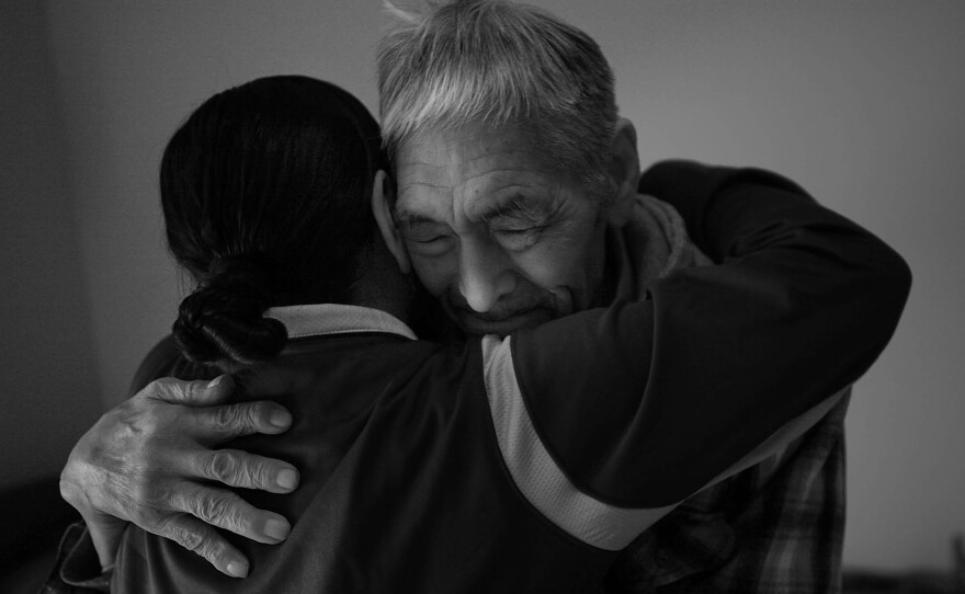 Frankie Kuzuguk, 82, gets a hug from his daughter Marilyn Kuzuguk at Quyanna Care Center in Nome, Alaska, after receiving an official honorable discharge and a distinguished service coin from visiting Veterans Affairs officials. The VA is still tracking down the few surviving members of the World War II Alaska Territorial Guard or delivering benefits to their next of kin.