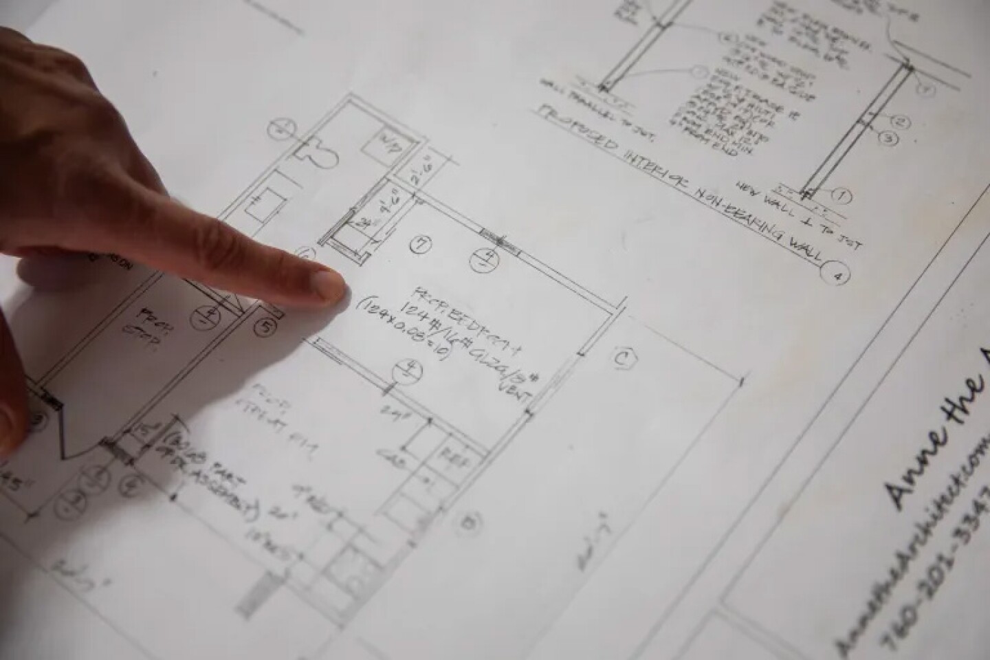 Adam Hardesty reviews the floor plans of the accessory dwelling unit he is building at his home in Carlsbad on Feb. 19, 2025.