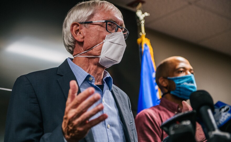 Wisconsin Gov. Tony Evers (left) speaks at a news conference held Thursday in Kenosha, Wis., to discuss recent civil unrest surrounding the police shooting of Jacob Blake, a Black man who was shot several times in the back in front of his children.