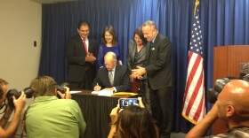 Gov. Jerry Brown signs California's $156 billion state budget in San Diego, June 20, 2014.