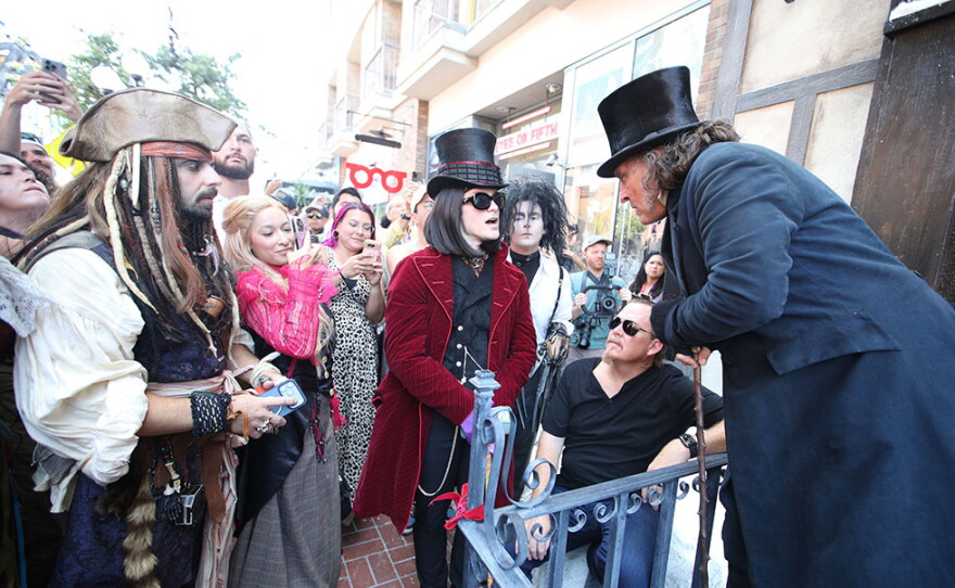 Johnny Depp, in costume as Ebenezer Scrooge greets cosplayers dressed as characters from his films during Comic-Con in San Diego on July 23, 2026.