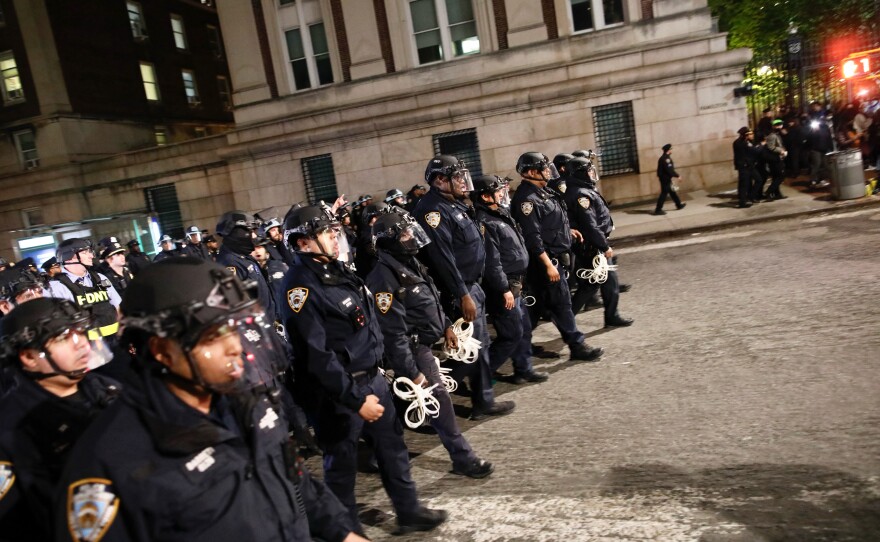 NYPD officers in riot gear march onto Columbia University campus, where pro-Palestinian students are barricaded inside a building and have set up an encampment, in New York City on April 30, 2024.