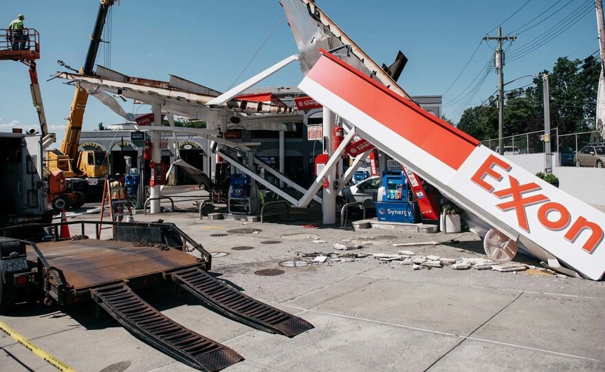 Workers clean a gas station damaged by the remnants of Hurricane Ida in New York City. Scientists warn that 60% of world oil reserves need to stay underground to avoid the worst impacts of climate change.