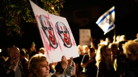 Israeli left-wing activists call for a government with Arab parties outside Yashar party leader Gadi Eisenkot's residence in Herzliya, Israel, Thursday.