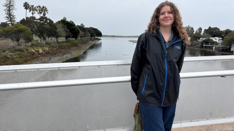 Savannah Stallings, with the San Diego Bird Alliance, stands on a bridge spanning Rose Creek as it flows into Mission Bay in San Diego. Dec. 31, 2025