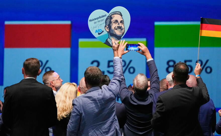 AfD supporters celebrate with a sign featuring top candidate Ulrich Siegmund after the first results of the Saxony-Anhalt state election at the party's election night gathering in Magdeburg, Germany, Sunday, Sept. 6, 2026.