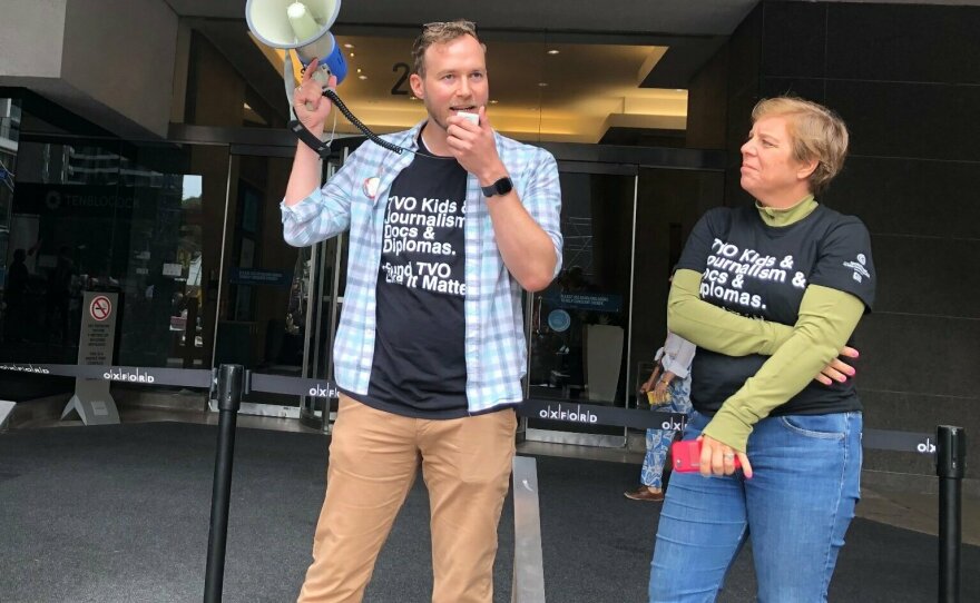 NewsGuild President Jon Schleuss speaks into a bullhorn at a rally of TVO employees in August 2023.