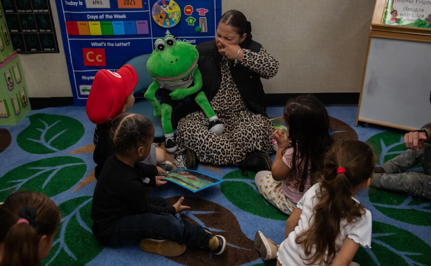 Teacher Viviana Vasquez works with students during class at Mi Escuelita in San Diego on April 23, 2025. All staff at Mi Escuelita are required to complete a 40-hour training offered by SBCS to help equip them with the knowledge and skills needed to support survivors of domestic violence, such as learning how it can affect children.