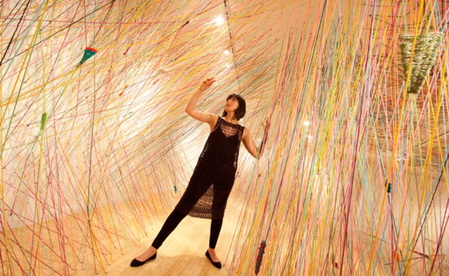 Tanya Aguiñiga in her 2011 installation at the Craft and Folk Art Museum, "Crossing the Line."