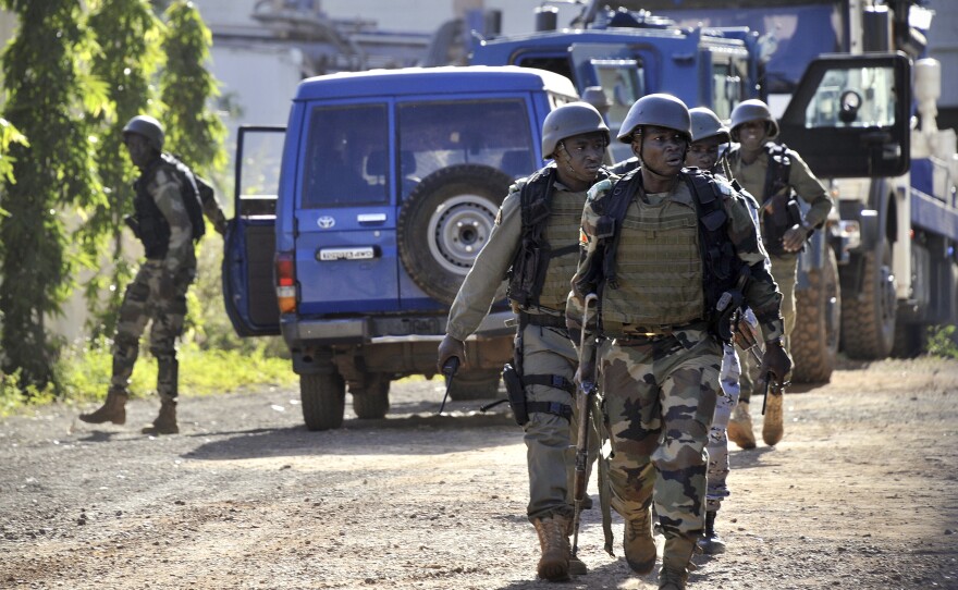 Malian troops take position. Several extremist groups currently operate in Mali; it's not yet clear who might be responsible for the hotel attack.