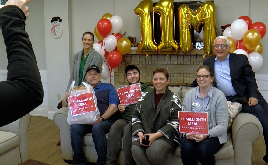 Meal recipient Thomas Willaredt is shown on the left with Mama's Kitchen CEO Alberto Cortes and Mama's Kitchen staff on December 16, 2022.