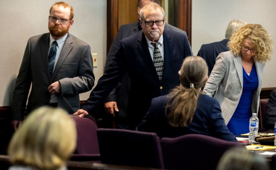 Greg McMichael, center, and his son, Travis McMichael, left, look at family members seated in the gallery when they walk into the courtroom for the reading of the jury's verdict for themselves and a neighbor, William "Roddie" Bryan in the Glynn County Courthouse on November 24, 2021 in Brunswick, Ga. The three men were changed with the February, 2020 fatal shooting of 25-year-old Ahmaud Arbery.