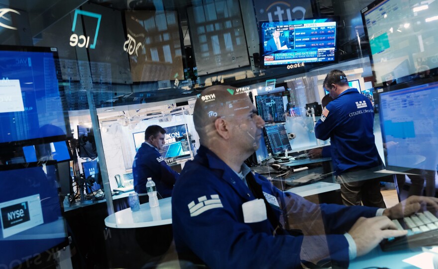 Traders work on the floor of the New York Stock Exchange on June 16. Stocks fell sharply in morning trading as investors react to the Federal Reserve's largest rate hike since 1994.