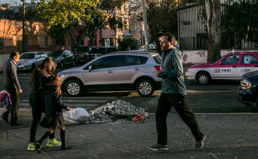 Dr. Tonatiuh Barrientos Gutierrez, an epidemiologist in Mexico City, jogs near his home in the southern part of the capital. He says it's hard to run on the city's streets.
