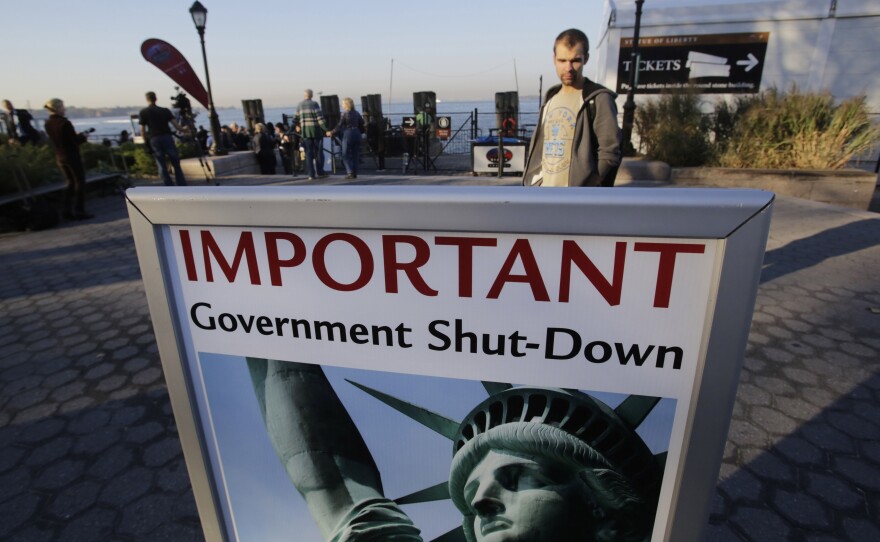 A sign announces the closing of the Statue of Liberty on Tuesday.