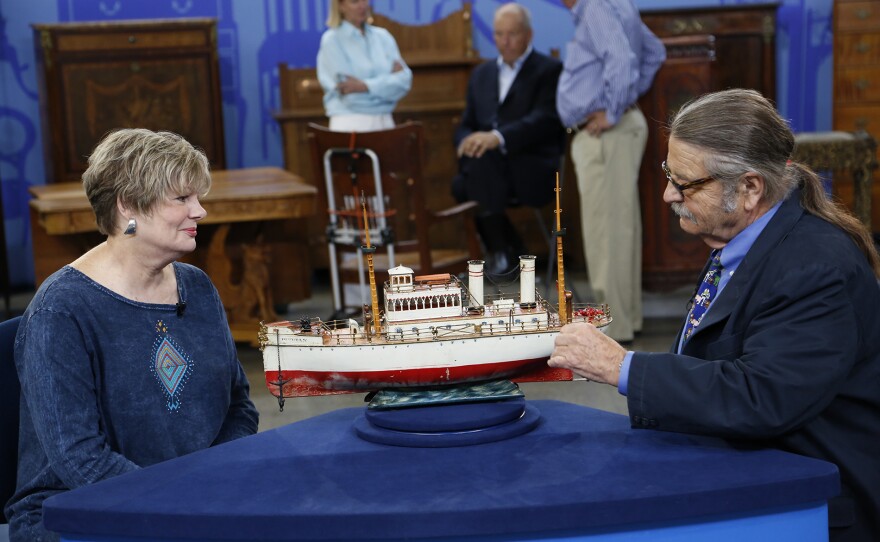 Noel Barrett (right) appraises a Marklin “Puritan” toy boat, ca. 1910, in Kansas City, Mo. ANTIQUES ROADSHOW “Kids Stuff” airs Monday, November 3 at 8/7C PM on PBS.
