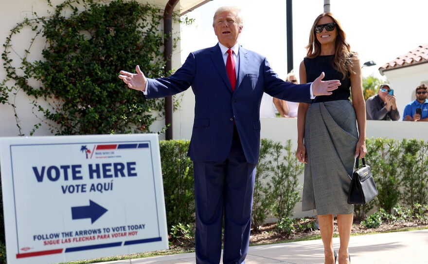 Former President Donald Trump stands with former first lady Melania Trump after voting in 2022.