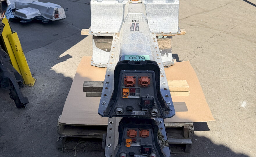 Two Chevy Volt batteries sit on a pallet at Everett Auto Parts in Brockton, Mass.