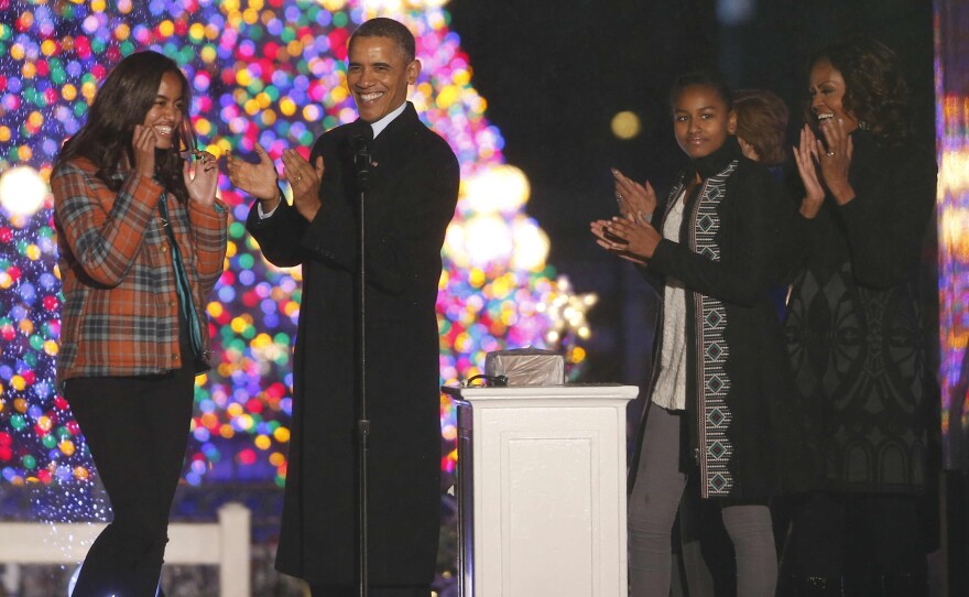 President Barack Obama, first lady Michelle Obama, daughters Sasha and Malia, applaud after lightng the National Christmas Tree at a ceremony across from the White House in Washington, on Friday.