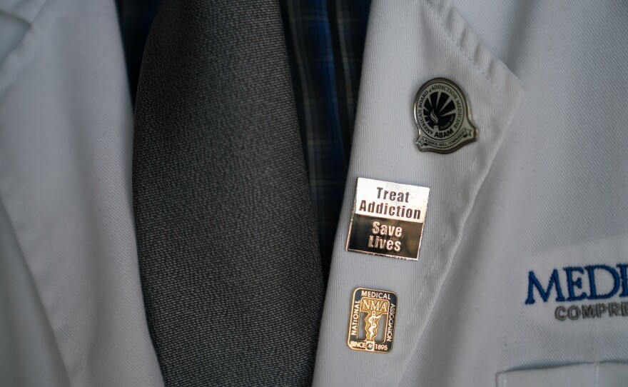 Chapman wears pins that signify his commitment to treating patients fighting addiction.