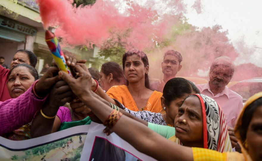People celebrate after police shot dead four detained gang-rape and murder suspects in Shadnagar, near Hyderabad, India, on Friday.