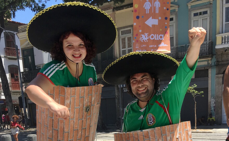 Brazilian journalists Luciana (left) and Fernando Miragaya are dressed as President Trump's Mexican Wall.