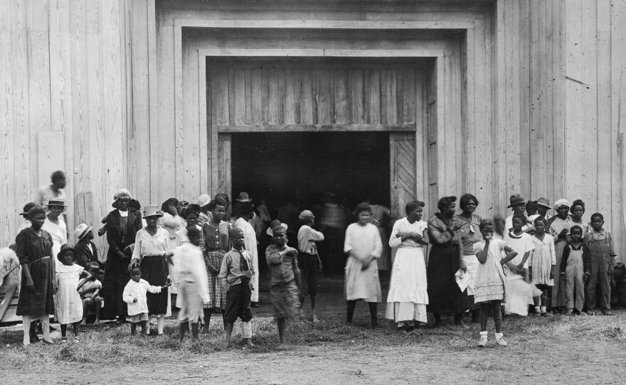 Black residents stand outside the entrance to a refugee camp on the fairgrounds in Tulsa after the massacre. Tulsa, and the nation, have been slow to acknowledge the brutal reality of what happened in 1921 and the lasting impact it's had on Black families.