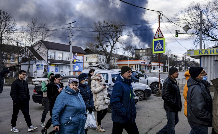 People line up in front of a supermarket in the Ukrainian town of Vasylkiv, just outside Kyiv on Feb. 27. Overnight, Russian strikes hit a nearby oil depot.